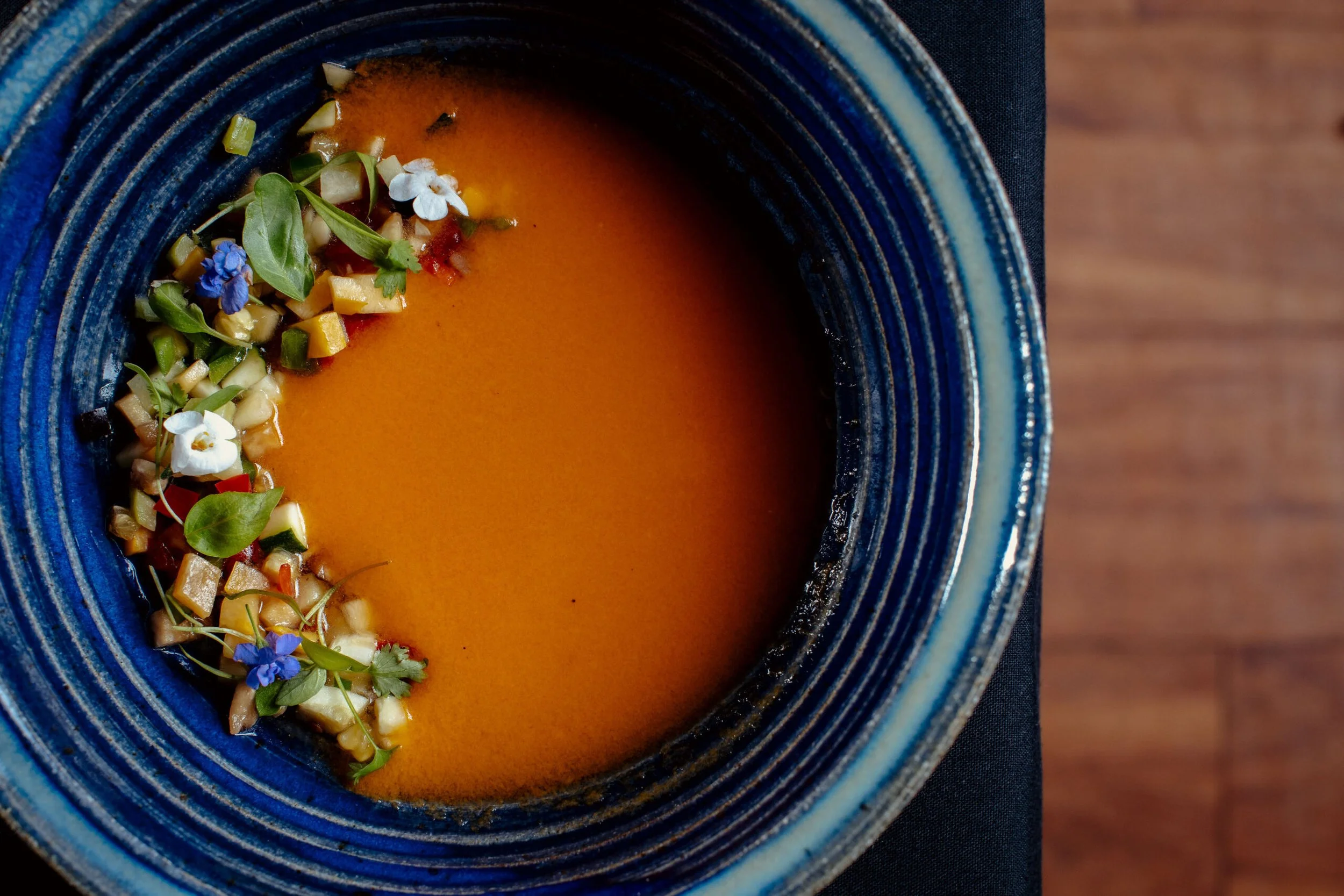 Seasonal soup course with edible flowers